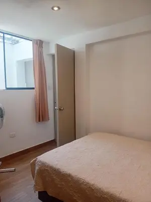a bedroom with a bed and a door with a window at Casa Sunampe Chincha in Sunampe
