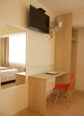a room with a desk and a mirror and a bed at Hotel San Remo in Lima
