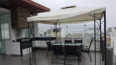 a table and chairs under a canopy on a balcony at Asia las terrazas casa in Asia