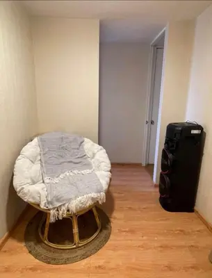 a room with a bed in the corner of a room at Acogedora habitación in Lima