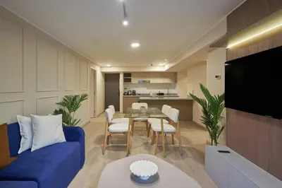 a living room with a blue couch and a table at Larco Prime Suites - Pool, Gym & Coworking in Lima