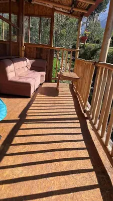a porch of a house with a couch and a table at Casa de Campo en el Valle Sagrado de los Incas, Urubamba - Unu Samay in Urubamba