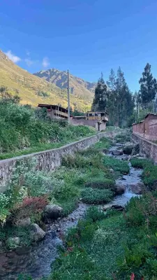 a river in a field with mountains in the background at Casa de Campo en el Valle Sagrado de los Incas, Urubamba - Unu Samay in Urubamba