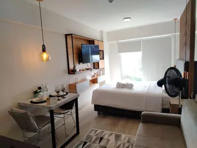 a bedroom with a bed and a table and a couch at Loft en Barranco in Lima
