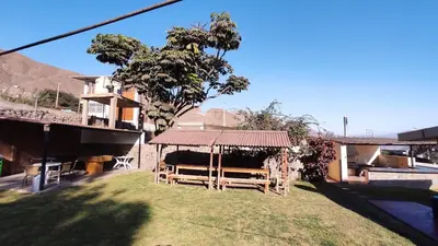 a yard with a gazebo and a house at Casa de campo Yangas para 20 personas in Yangas