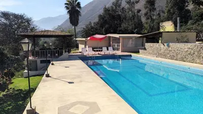 a swimming pool in front of a house at Casa de campo Yangas para 20 personas in Yangas