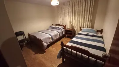 a bedroom with two beds and a window at Casa de campo Yangas para 20 personas in Yangas