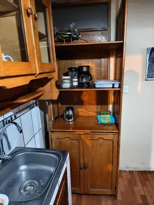 a small kitchen with a sink and a stove at Mayu House Inn IV en el centro histórico in Cusco