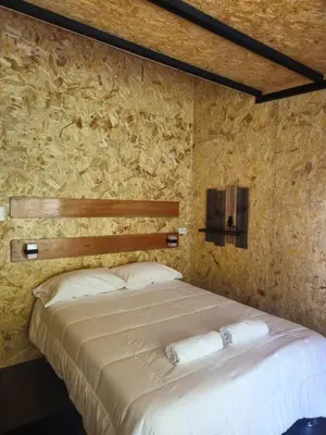 a bedroom with a bed with two towels on it at La Montaña Lodge - Oxapampa in Oxapampa
