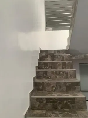 a stone staircase in a house with a window at Acogedores pisos en el valle de Mala in Mala