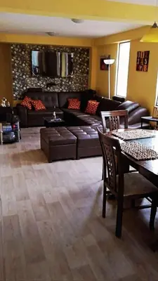 a living room with a couch and a table at Residencial Huancaro Apartament in Cusco