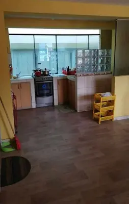 an empty kitchen with a stove and a counter top at Residencial Huancaro Apartament in Cusco