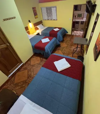 a hotel room with two beds in a room at Hospedaje San Francisco in Machu Picchu