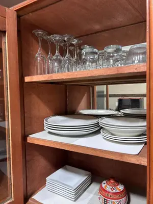 a shelf with plates and glasses on it at Apartamento Quillque House in Cusco