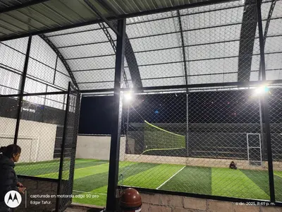 a view of a baseball field from inside a batting cage at Nuevo campo verde eirl in Lima