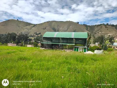 a building with a green roof in a field at Nuevo campo verde eirl in Lima