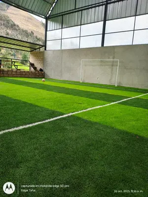 an indoor soccer field with a soccer ball on it at Nuevo campo verde eirl in Lima