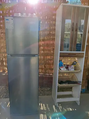 a stainless steel refrigerator next to a cabinet at Casa rústica in Ica