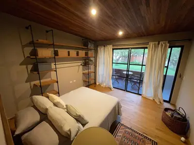 a bedroom with a bed with pillows and a book shelf at Country House in Azpitia Villa las Leñas in Santa Cruz de Flores