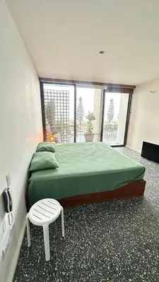a bedroom with two beds and a stool in it at Casa joyas in Islote Los Leones