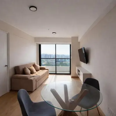 a living room with a glass table and chairs at Modern Apartment with AC and Pool near Miraflores, Fast WiFi in Lima