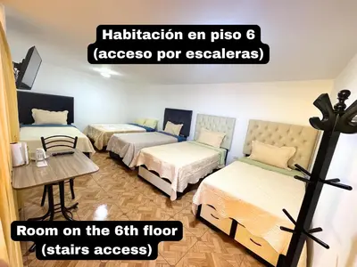 a room with three beds and a sign that reads room on the floor at Private Apartment Close to Airport - Airport Shuttle Available in Lima