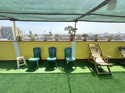 a group of chairs sitting on top of a roof at Private Apartment Close to Airport - Airport Shuttle Available in Lima