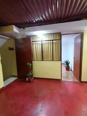 an empty room with two doors and a red floor at Private Apartment Close to Airport - Airport Shuttle Available in Lima