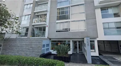a large apartment building with a door and stairs at Coliving Barranco in Lima