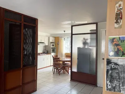 a kitchen and dining room with a table and chairs at Confortable and central in Lima