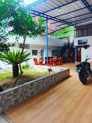 a motorcycle parked in front of a house at Alojamiento Oslo San Ramón in San Ramón