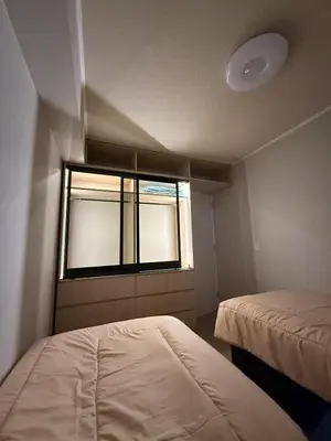 a small room with two beds and a window at Brand New Apartment in Lima