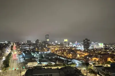 a city lit up at night with lights at Departamento céntrico a San Isidro San Borja in Lima