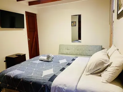 a bedroom with a bed with a stuffed animal on it at Mini Depa Luminoso con Cocina, a Pasos del Parque Kennedy Miraflores in Lima