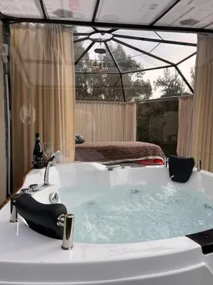a bath tub with a sink and a bed at Cusco Sana Lodge in Cusco