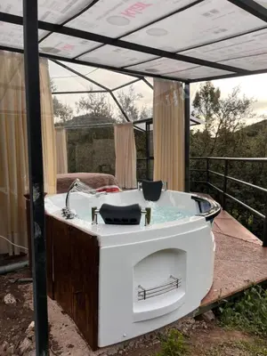 a bath tub sitting under a tent with at Cusco Sana Lodge in Cusco