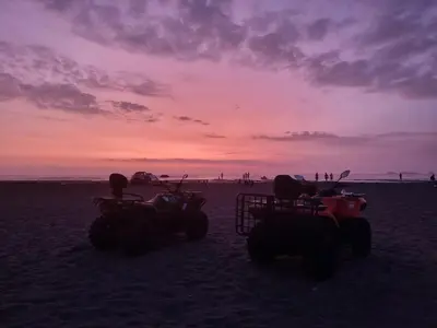 two atvs on the beach with a sunset in the background at Casa de Playa en Puerto Viejo in Puerto Viejo