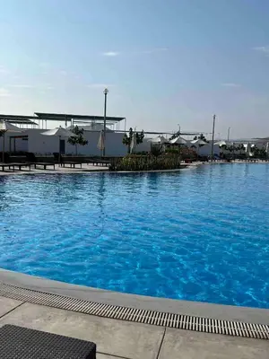a large pool of blue water in front of a building at Casa de Playa en Puerto Viejo in Puerto Viejo