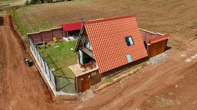 an aerial view of a house in a field at Alpine Cabin Quito in Cusco