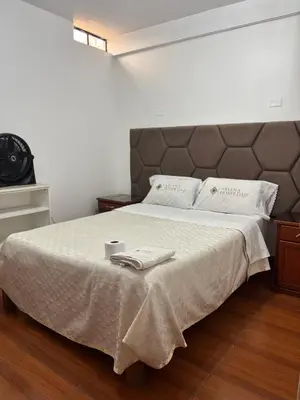 a bedroom with a large bed with two towels on it at Hospedaje Ariana in Supe