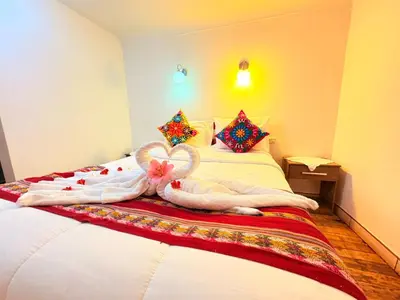 a bed with a heart made out of towels at Horizonte Hotels in Cusco