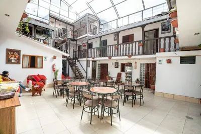 a room with tables and chairs and a glass ceiling at Horizonte Hotels in Cusco