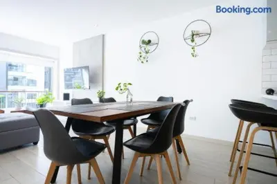 a dining room with a wooden table and chairs at Barranco-Miraflores 2BR OceanView Modern Apt up to 6 guests! in Lima