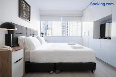 a bedroom with a large bed and a television at Barranco-Miraflores 2BR OceanView Modern Apt up to 6 guests! in Lima