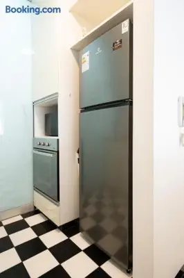 a kitchen with a refrigerator and a checkered floor at Barranco-Miraflores 2BR OceanView Modern Apt up to 6 guests! in Lima