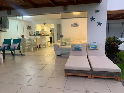 two beds in a room with a living room at Beach House - Condominio Asia Bonita in Asia