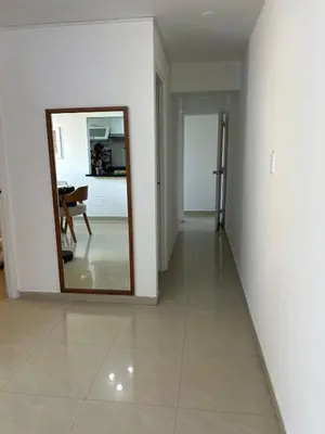 a hallway with a mirror and a table in a room at Spacious and bright apartment with a beautiful view in Lima