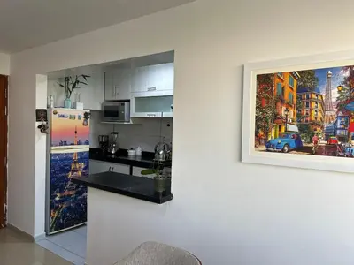 a kitchen with a painting hanging on a wall at Spacious and bright apartment with a beautiful view in Lima