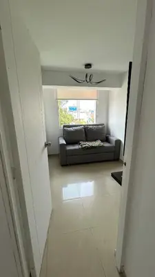a living room with a couch and a window at Spacious and bright apartment with a beautiful view in Lima