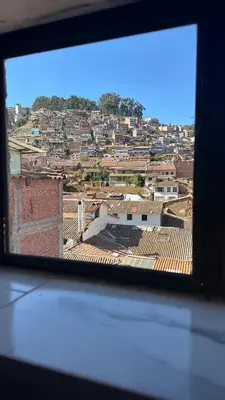 a view of a city from a window at Cozy room with kitchenette and private bathroom in Cusco